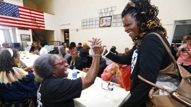 Black women grasping hands